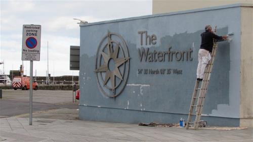 The Waterfront sign being painted
