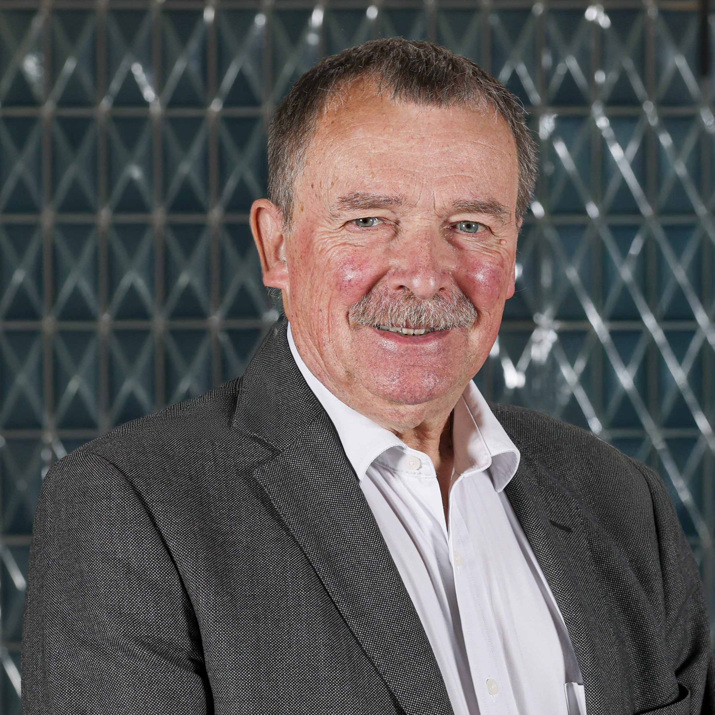 Headshot of Dr. Alan Whitehead, CBE